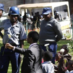 Sten Zvorwadza and Itai Dzamara’s children present Zimbabwe Republic Police “tokens of love” 17 months after Itai disappeared. / Photo Credit: Philimon Bulawayo 
