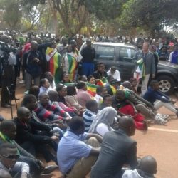 11:44 Emotional moments as people sit in front of the court and start singing / Photo Credit: NewsDay